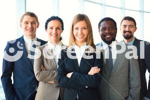 Group Of Business Partners Looking At Camera With Smiles